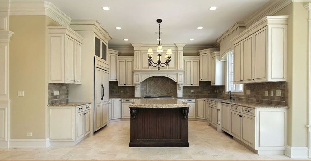 High-end traditional kitchen with cream cabinets and granite island in Naples