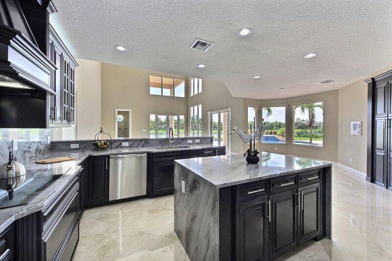 Luxury U-shaped kitchen with marble floors and custom cabinetry Naples FL